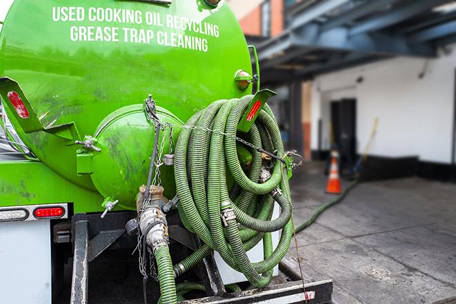 a grease trap being pumped by a sanitation technician in Shafter, CA